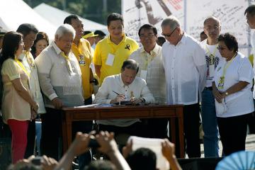 PNoy signs martial law compensation bill at EDSA rites