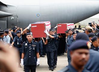 Bodies of two Malaysian cops killed in Sabah clash arrive in KL